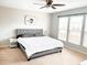Large bedroom with natural light features plush carpet, a large window, and a ceiling fan at 1129 Kudzu St, Durham, NC 27713