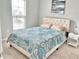 Comfortable bedroom with ample natural light features plush carpet, a side table, and a decorative print at 1129 Kudzu St, Durham, NC 27713