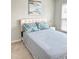 Bright bedroom featuring a neutral color scheme, plush carpet and a decorative print above the headboard at 1129 Kudzu St, Durham, NC 27713
