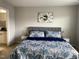 Comfortable bedroom featuring neutral walls and carpet, two side tables, and decorative flower print at 1129 Kudzu St, Durham, NC 27713
