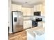 Modern kitchen boasts stainless steel appliances, granite countertops, and bright white cabinets at 1129 Kudzu St, Durham, NC 27713
