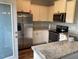 Modern kitchen featuring white cabinetry, stainless steel appliances, and granite countertops at 1129 Kudzu St, Durham, NC 27713