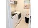Efficient laundry area with modern washer, dryer, storage shelves, and stylish decor at 1129 Kudzu St, Durham, NC 27713
