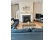 Bright living room with a fireplace, a TV, and comfortable seating arrangement perfect for relaxing at 1129 Kudzu St, Durham, NC 27713