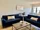 Comfortable living area with blue sofas, neutral walls, and a stylish decor creating a cozy atmosphere at 1129 Kudzu St, Durham, NC 27713
