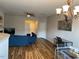 Spacious living room featuring hardwood floors, comfortable seating, and ample natural light at 1129 Kudzu St, Durham, NC 27713