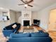 Open-concept living room with a fireplace, modern furniture, and natural light at 1129 Kudzu St, Durham, NC 27713