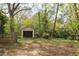 Backyard and storage shed with black doors and stone paver pathway at 1208 College Pl, Raleigh, NC 27605