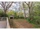 View of the backyard, storage shed, and surrounding trees and foliage at 1208 College Pl, Raleigh, NC 27605