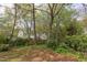 Looking out over the yard with mature trees and other residential homes in the background at 1208 College Pl, Raleigh, NC 27605