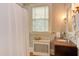 Elegant bathroom features patterned tile walls, a vanity, and natural light from the window at 1208 College Pl, Raleigh, NC 27605