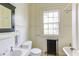 Traditional bathroom with vintage fixtures and black framed mirror at 1208 College Pl, Raleigh, NC 27605