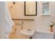 Bright bathroom with tiled walls, pedestal sink, classic fixtures, and accessible shower at 1208 College Pl, Raleigh, NC 27605