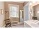 A traditional style bathroom with vanity and view to a second bathroom at 1208 College Pl, Raleigh, NC 27605