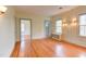 Bedroom features hardwood floors, bright windows, and pastel blue molding at 1208 College Pl, Raleigh, NC 27605