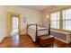 Charming bedroom showcases hardwood floors, bright windows, and a decorative wood burning fireplace at 1208 College Pl, Raleigh, NC 27605