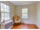 Bedroom featuring warm lighting, hardwood floors, large windows, and neutral walls at 1208 College Pl, Raleigh, NC 27605