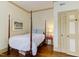 Cozy bedroom boasts a four-poster bed, wooden floors, and a serene ambiance at 1208 College Pl, Raleigh, NC 27605