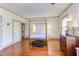 Large bedroom features wood floors, paneled walls and a four poster bed with modern lighting at 1208 College Pl, Raleigh, NC 27605