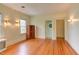Spacious bedroom with hardwood floors, bright windows, decorative sconces and white trim at 1208 College Pl, Raleigh, NC 27605