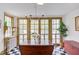 Charming breakfast nook with a chandelier, french doors, and vintage-style checkered flooring at 1208 College Pl, Raleigh, NC 27605