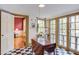 Bright breakfast nook with tiled flooring, featuring views into the living room and french doors at 1208 College Pl, Raleigh, NC 27605