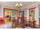 Dining room with hardwood floors and antique dining table leading into a living area and kitchen space at 1208 College Pl, Raleigh, NC 27605