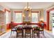 Charming dining room with a large table, floral wallpaper, and bright windows creating an inviting space at 1208 College Pl, Raleigh, NC 27605