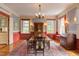 Formal dining room with a large table, chandelier, and decorative wallpaper for elegant entertaining at 1208 College Pl, Raleigh, NC 27605
