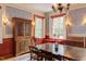 Beautiful dining room featuring a large wooden table, shuttered windows, and antique-style furnishings at 1208 College Pl, Raleigh, NC 27605