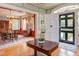 Bright foyer with hardwood floors, offering a view of the dining room with a large table and window seats at 1208 College Pl, Raleigh, NC 27605
