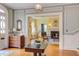 Welcoming foyer with hardwood floors leads to a cozy living room with a fireplace and plenty of natural light at 1208 College Pl, Raleigh, NC 27605