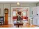 Spacious foyer leading to a dining room, showcasing an antique grandfather clock and hardwood floors at 1208 College Pl, Raleigh, NC 27605