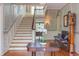 Grand foyer with hardwood floors, staircase, elegant wainscoting, and refined decor at 1208 College Pl, Raleigh, NC 27605