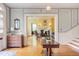 Inviting foyer with hardwood floors, detailed molding, and a glimpse into the living room fireplace at 1208 College Pl, Raleigh, NC 27605