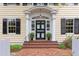 Close-up of the front entrance featuring a black door with white trim and brick steps with the house number 1208 at 1208 College Pl, Raleigh, NC 27605