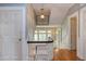 Second floor hallway with wood floors, pale blue walls, and a decorative hanging light fixture at 1208 College Pl, Raleigh, NC 27605