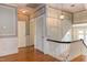 Hallway features wood floors, blue walls with white trim, and a staircase with wood railing at 1208 College Pl, Raleigh, NC 27605
