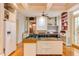 Spacious kitchen with a center island, custom cabinetry, and open layout to the Gathering room at 1208 College Pl, Raleigh, NC 27605