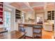 Open kitchen with custom shelving, white cabinets, and hardwood floors at 1208 College Pl, Raleigh, NC 27605