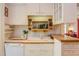 Kitchen features white cabinets, countertops, and modern appliances at 1208 College Pl, Raleigh, NC 27605