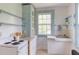 Vintage kitchen featuring pastel blue molding, and cabinets, with white appliances at 1208 College Pl, Raleigh, NC 27605