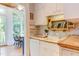Bright kitchen features white cabinets, a modern sink and hardwood floors at 1208 College Pl, Raleigh, NC 27605