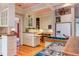 Well-lit kitchen features white cabinets, tile countertops, and modern appliances at 1208 College Pl, Raleigh, NC 27605
