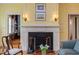 Living room featuring hardwood floors, a fireplace, and classic architectural design at 1208 College Pl, Raleigh, NC 27605