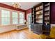 Living room filled with light, hardwood floors, traditional windows, and stylish built-in shelving at 1208 College Pl, Raleigh, NC 27605