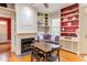 Living room boasts custom built-ins, a cozy fireplace and hardwood floors at 1208 College Pl, Raleigh, NC 27605