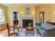 Bright living room showcasing yellow walls, a fireplace, wood floors, and traditional furnishings at 1208 College Pl, Raleigh, NC 27605