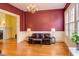 Elegant living room featuring hardwood floors, classic details, and comfortable leather furniture at 1208 College Pl, Raleigh, NC 27605