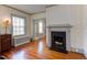 Elegant living room boasts beautiful hardwood floors, a fireplace, and classic trim at 1208 College Pl, Raleigh, NC 27605
